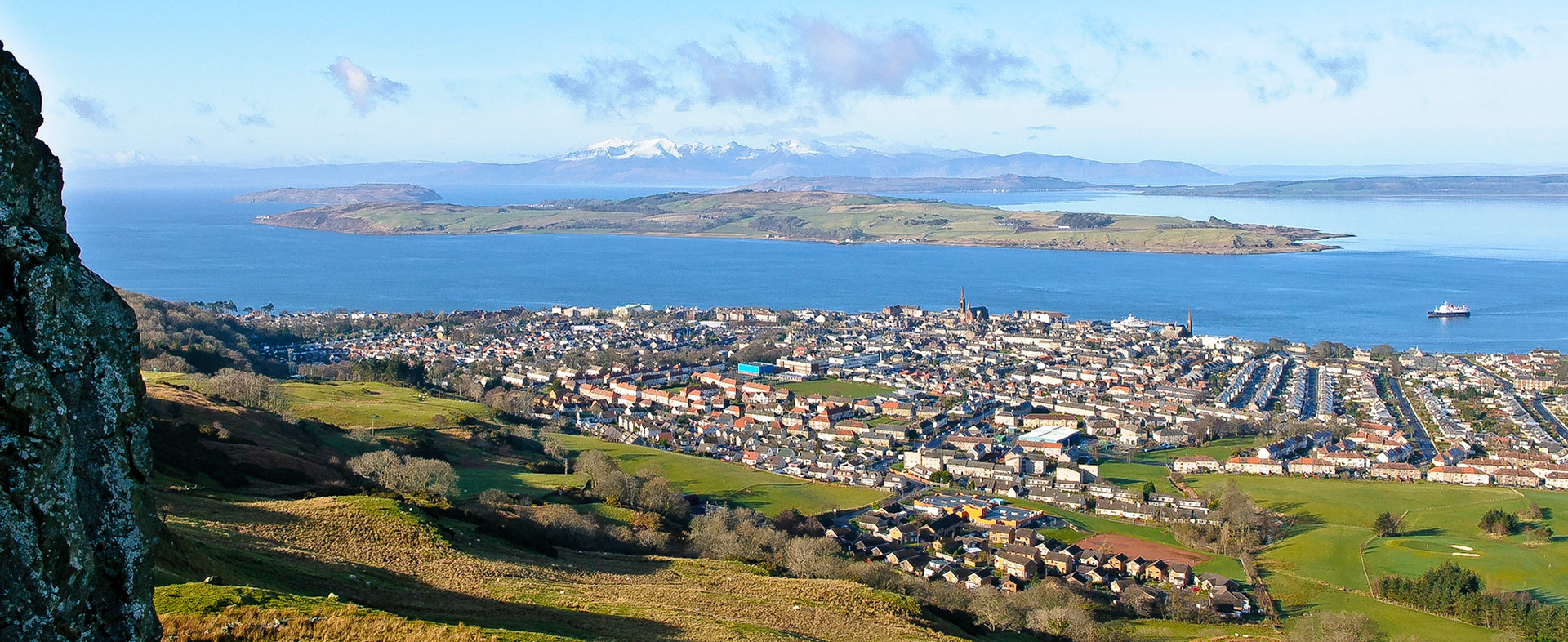 panorama of Largs from above showing snow-peaked Arran, the Cumbraes and Bute.